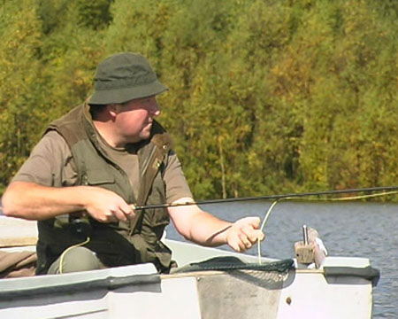 Man Fly Fishing in Boat, Arnfield Fly Fishery